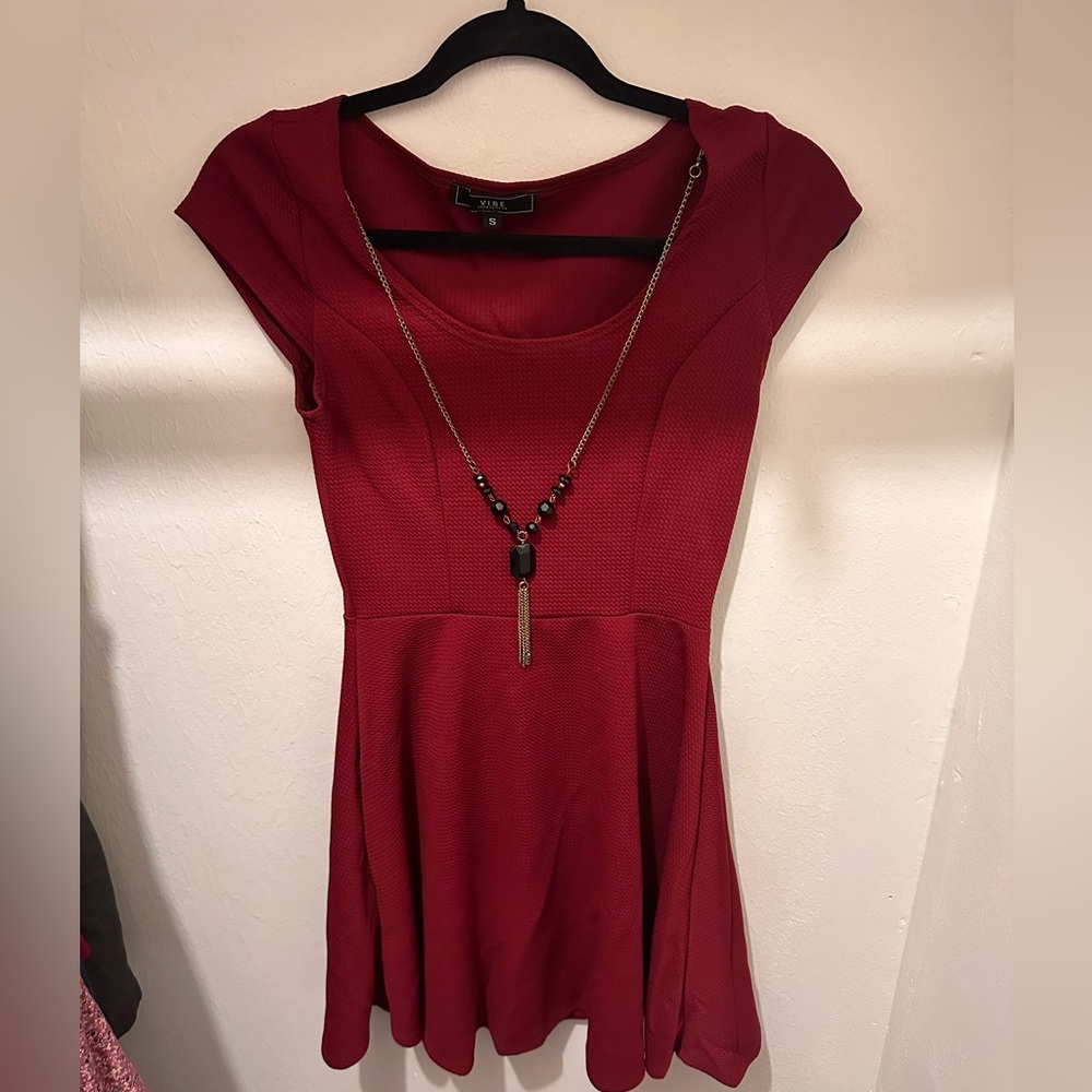 Size small A line swing dress with attached jewelry.